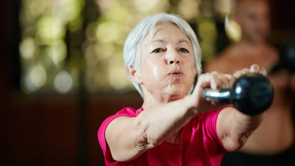 Person performing arm exercises with dumbbells Melksham